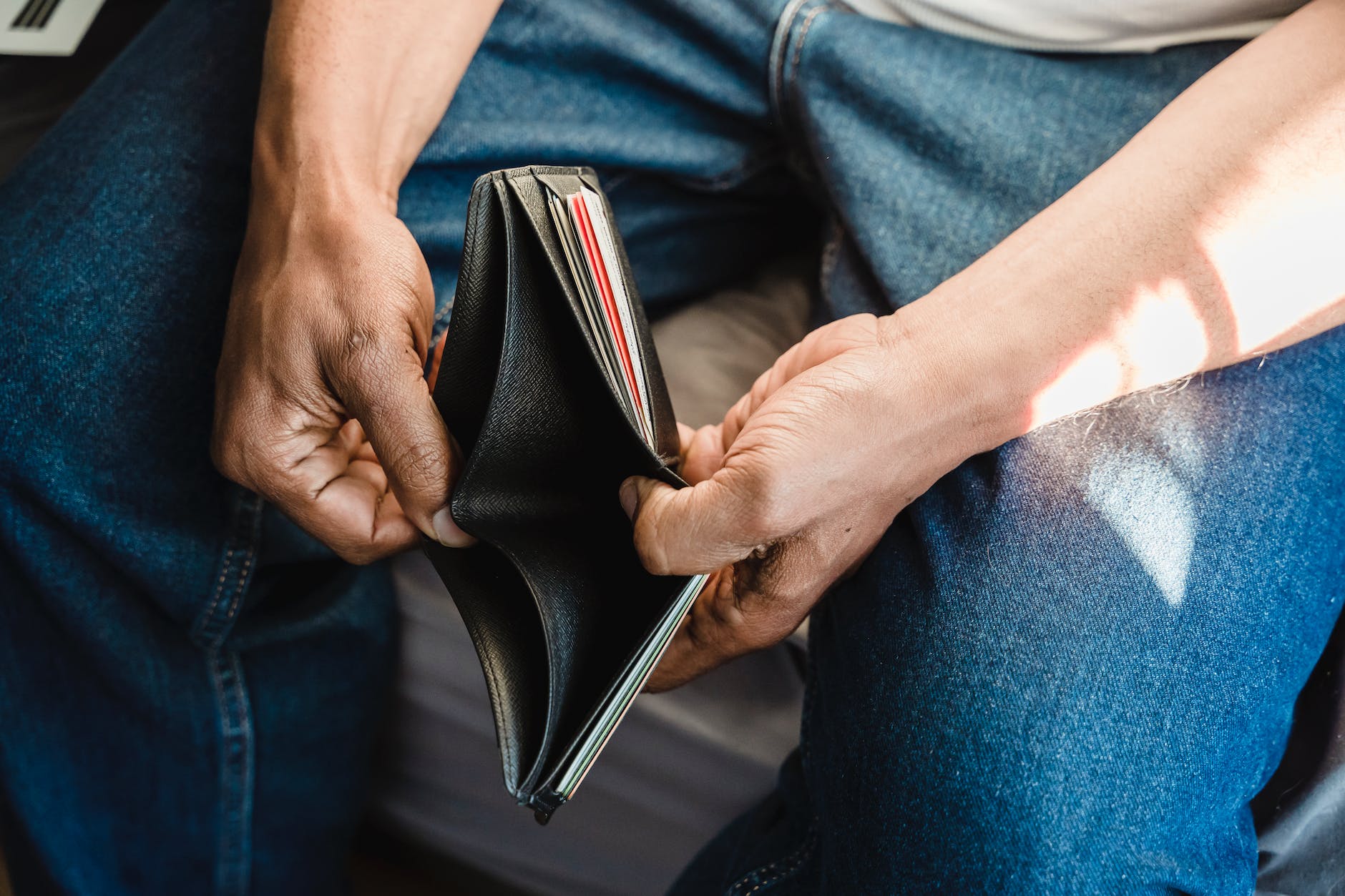 man looking at an empty wallet