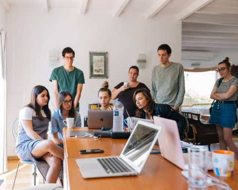 group of people watching on laptop