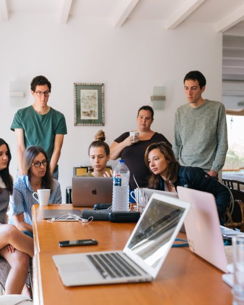 group of people watching on laptop