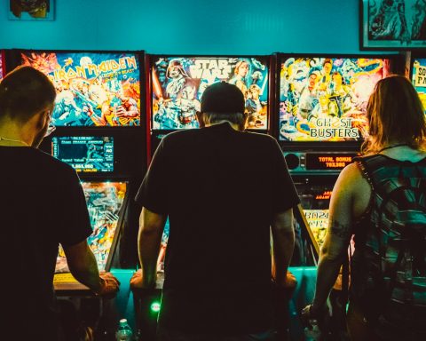 people playing arcade machines