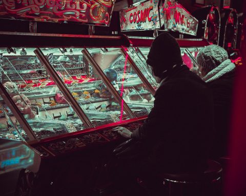 person playing on arcade machine