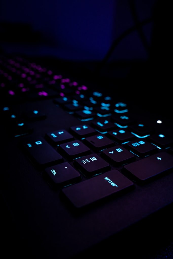 black computer keyboard on blue textile