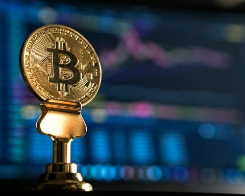 selective focus photo of Bitcoin near monitor