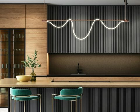 a modern kitchen with a bar and stools